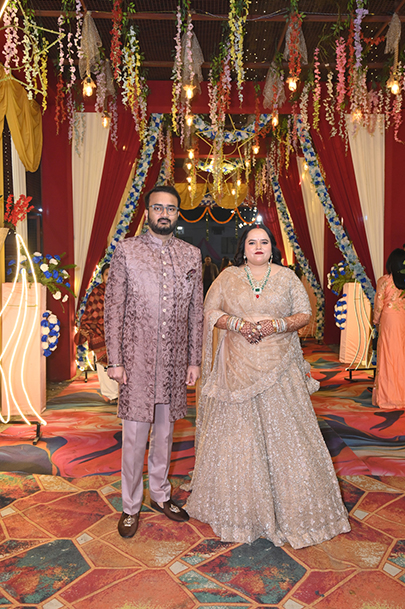 Aneesh and Priyanka sharing a candid moment amid wedding decorations in Prayagraj