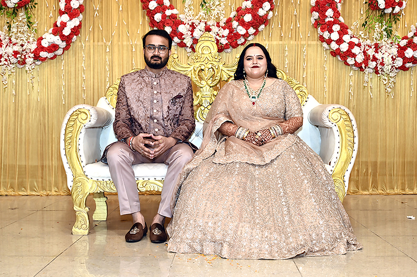 Bride and groom seated on wedding stage