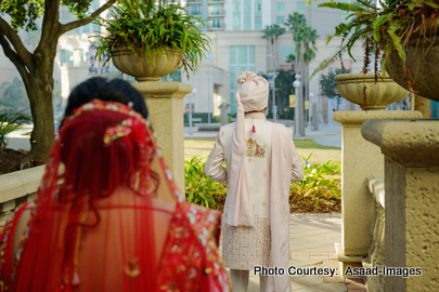 Groom Bhaumik walking ahead as bride Tithi approaches during wedding first-look moment