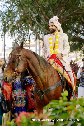 Groom Bhaumik riding a horse during traditional Indian baraat ceremony in Tampa