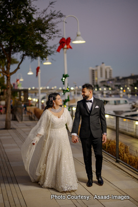 Tithi and Bhaumik walking hand in hand during nighttime wedding photoshoot in Tampa