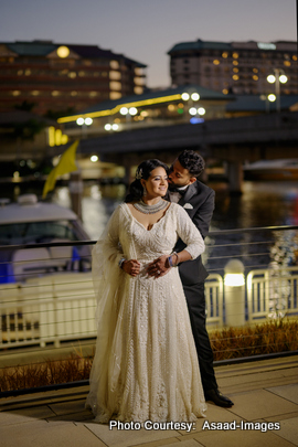 Bride Tithi posing alone at night in elegant wedding gown with city backdrop
