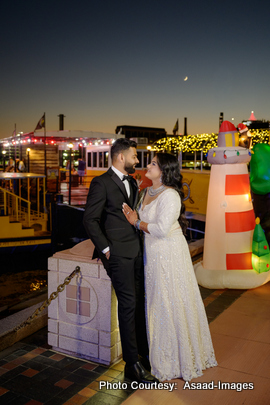 Tithi and Bhaumik posing together at night with city skyline during wedding photoshoot