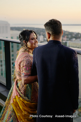 Tithi and Bhaumik holding hands and looking at city skyline during wedding photoshoot