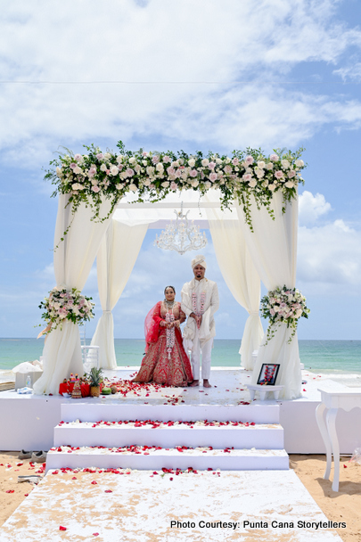 Indian bride and groom under wedding mandap