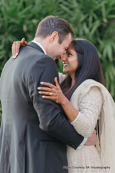 Bride Sujata and groom Mark hugging lovingly during wedding photoshoot