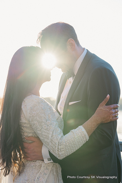 Sujata and Mark sharing a romantic embrace during their wedding photoshoot