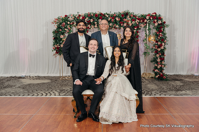 Sujata and Mark posing with close family members at their wedding reception