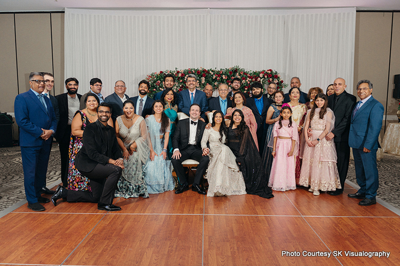 Large group of wedding guests posing together at Sujata and Mark wedding reception