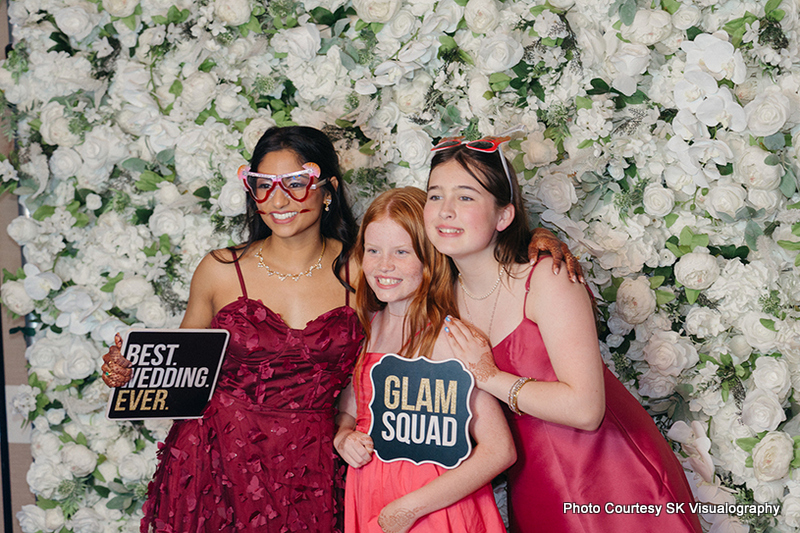 Wedding guests posing at photo booth during Sujata and Mark wedding celebration